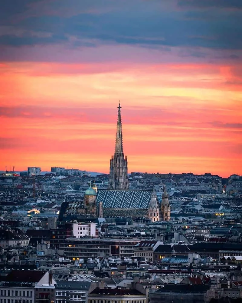 Vienna skyline with St Stephen’s Cathedral beneath a pink and orange sunset